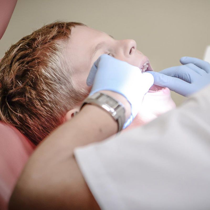 Dentist Working on Childs Teeth Dentist Working on Childs Teeth